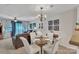 Bright dining area with a glass table, chandelier, and access to the living room at 11218 Grass Field Rd # 1083, Charlotte, NC 28213
