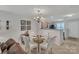 Cozy dining space with a view to the kitchen, living room, and staircase at 11218 Grass Field Rd # 1083, Charlotte, NC 28213