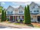 Attractive townhouse exterior with brick facade, covered porch, and mature trees at 11218 Grass Field Rd # 1083, Charlotte, NC 28213