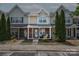 Charming townhouse exterior with brick accents and covered porch seating area at 11218 Grass Field Rd # 1083, Charlotte, NC 28213