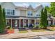 Inviting townhouse exterior with well-manicured landscaping and covered front porch at 11218 Grass Field Rd # 1083, Charlotte, NC 28213