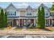 Attractive townhouse exterior with brick facade, covered porch, and mature trees at 11218 Grass Field Rd # 1083, Charlotte, NC 28213