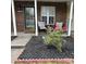 Inviting brick front porch with charming seating area and well-maintained landscaping at 11218 Grass Field Rd # 1083, Charlotte, NC 28213