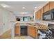 Open kitchen with wood cabinets and a view into the dining and living areas at 11218 Grass Field Rd # 1083, Charlotte, NC 28213