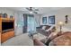 Comfortable living room with TV, ceiling fan, and sliding glass doors at 11218 Grass Field Rd # 1083, Charlotte, NC 28213