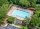 An aerial view showing a large community pool with lounge chairs and a clubhouse, perfect for summer relaxation at 11218 Grass Field Rd # 1083, Charlotte, NC 28213