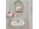 Stylish powder room with oval mirror, modern vanity, and decorative accents at 11218 Grass Field Rd # 1083, Charlotte, NC 28213