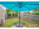 Backyard with an outdoor table underneath a blue umbrella and a wooden fence at 11714 Harsworth Ln, Charlotte, NC 28277