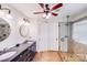 Bathroom with dual sinks, walk-in shower, and a ceiling fan above at 11714 Harsworth Ln, Charlotte, NC 28277