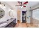 Bathroom with dual sinks, walk-in shower, and a ceiling fan above at 11714 Harsworth Ln, Charlotte, NC 28277