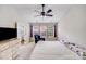 Bright bedroom with a ceiling fan and large windows, complete with a closet and dresser at 11714 Harsworth Ln, Charlotte, NC 28277