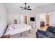Bright bedroom including ceiling fan, dresser, TV, and access to a full bathroom at 11714 Harsworth Ln, Charlotte, NC 28277