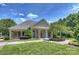 Charming clubhouse with an inviting front porch, manicured lawn, and beautiful landscaping at 11714 Harsworth Ln, Charlotte, NC 28277