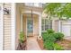 Inviting front entrance with a decorative door, plants, and well-maintained landscaping at 11714 Harsworth Ln, Charlotte, NC 28277