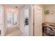 Bright hallway with a view to an office area, showing access to the laundry room at 11714 Harsworth Ln, Charlotte, NC 28277