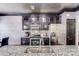 Modern kitchen with stainless steel appliances, granite countertops, and decorative backsplash at 11714 Harsworth Ln, Charlotte, NC 28277