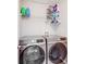 Modern laundry room featuring newer washer and dryer with shelving for storage at 11714 Harsworth Ln, Charlotte, NC 28277