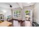 Bright living area featuring hardwood floors, crown molding, and a large window at 11714 Harsworth Ln, Charlotte, NC 28277