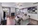 Spacious living area with fireplace, hardwood floors, and kitchen view at 11714 Harsworth Ln, Charlotte, NC 28277