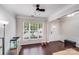 Bright living area featuring hardwood floors, crown molding, and a large window at 11714 Harsworth Ln, Charlotte, NC 28277