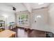 Bright living area featuring hardwood floors, crown molding, and a large window at 11714 Harsworth Ln, Charlotte, NC 28277