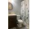 Bathroom featuring a vanity with a dark wood cabinet, toilet, and a shower with a decorative curtain at 120 Booker St, Wingate, NC 28112