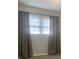 Bedroom features carpet, large windows with blinds, and gray curtains at 120 Booker St, Wingate, NC 28112