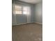 Bedroom with large windows providing natural light and neutral carpeting at 120 Booker St, Wingate, NC 28112
