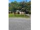 A single-story brick home with a well-kept lawn and mature trees in a serene, tree-lined neighborhood at 120 Booker St, Wingate, NC 28112