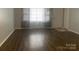 Living room featuring new hardwood floors, modern gray curtains, and a neutral color scheme at 120 Booker St, Wingate, NC 28112