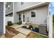 A cozy back patio with chairs, plants, and an air conditioning unit at 1201 Township Pkwy, Belmont, NC 28012