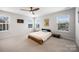 Bright bedroom with multiple windows and carpet floors offering a serene and airy atmosphere at 1201 Township Pkwy, Belmont, NC 28012