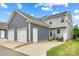 Rear exterior view showing gray siding, garage, and a small patio area at 1201 Township Pkwy, Belmont, NC 28012