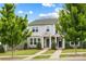 Charming gray two-story townhome featuring stone accents, a manicured lawn, and inviting curb appeal at 1201 Township Pkwy, Belmont, NC 28012