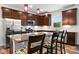 Well-equipped kitchen with stainless steel appliances, granite counters, and a breakfast bar with colorful stools at 1201 Township Pkwy, Belmont, NC 28012