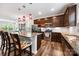 Open-concept kitchen featuring dark cabinets, stainless steel appliances, and an island with seating at 1201 Township Pkwy, Belmont, NC 28012