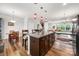 A Kitchen island with wooden cabinets and granite countertops in an open-concept kitchen and dining room at 1201 Township Pkwy, Belmont, NC 28012