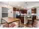 Warm kitchen with dark cabinets, stainless steel appliances, granite countertops, and pendant lighting at 1201 Township Pkwy, Belmont, NC 28012