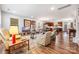 Bright and airy open-concept living space with hardwood floors connecting the kitchen, dining, and living areas at 1201 Township Pkwy, Belmont, NC 28012
