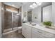 Bathroom featuring a glass-enclosed shower, white vanity, and neutral stone flooring at 1284 Independence St, Fort Mill, SC 29708