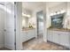 Bright primary bath features dual vanities, granite counters, and access to closet at 1284 Independence St, Fort Mill, SC 29708