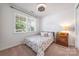Cozy bedroom with natural light, a ceiling fan, and a charming wooden nightstand with lamp at 1284 Independence St, Fort Mill, SC 29708