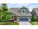 Charming two-story home boasts a blue exterior, well-manicured landscaping, and a two-car garage at 1284 Independence St, Fort Mill, SC 29708