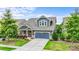 Beautiful two-story home with a well-kept lawn, flowering shrubs, and a two-car garage at 1284 Independence St, Fort Mill, SC 29708