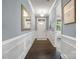 Inviting hallway features elegant molding, dark wood floors, a mirror, and a view of the front door at 1284 Independence St, Fort Mill, SC 29708