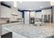 Modern kitchen with stainless steel appliances, white cabinets, and a spacious granite countertop island at 1284 Independence St, Fort Mill, SC 29708