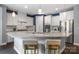 Modern kitchen with stainless steel appliances, white cabinets, and a spacious granite countertop island and bar seating at 1284 Independence St, Fort Mill, SC 29708