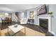 Cozy living room with fireplace, TV, area rug, and stairs to the second floor at 1284 Independence St, Fort Mill, SC 29708