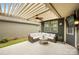 Comfortable covered patio with stylish seating, ceiling fan and lighting, ideal for relaxation and outdoor living at 1284 Independence St, Fort Mill, SC 29708