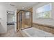 Bright bathroom featuring a bathtub, separate shower, and tile surround at 1300 Yellow Springs Dr, Indian Land, SC 29707